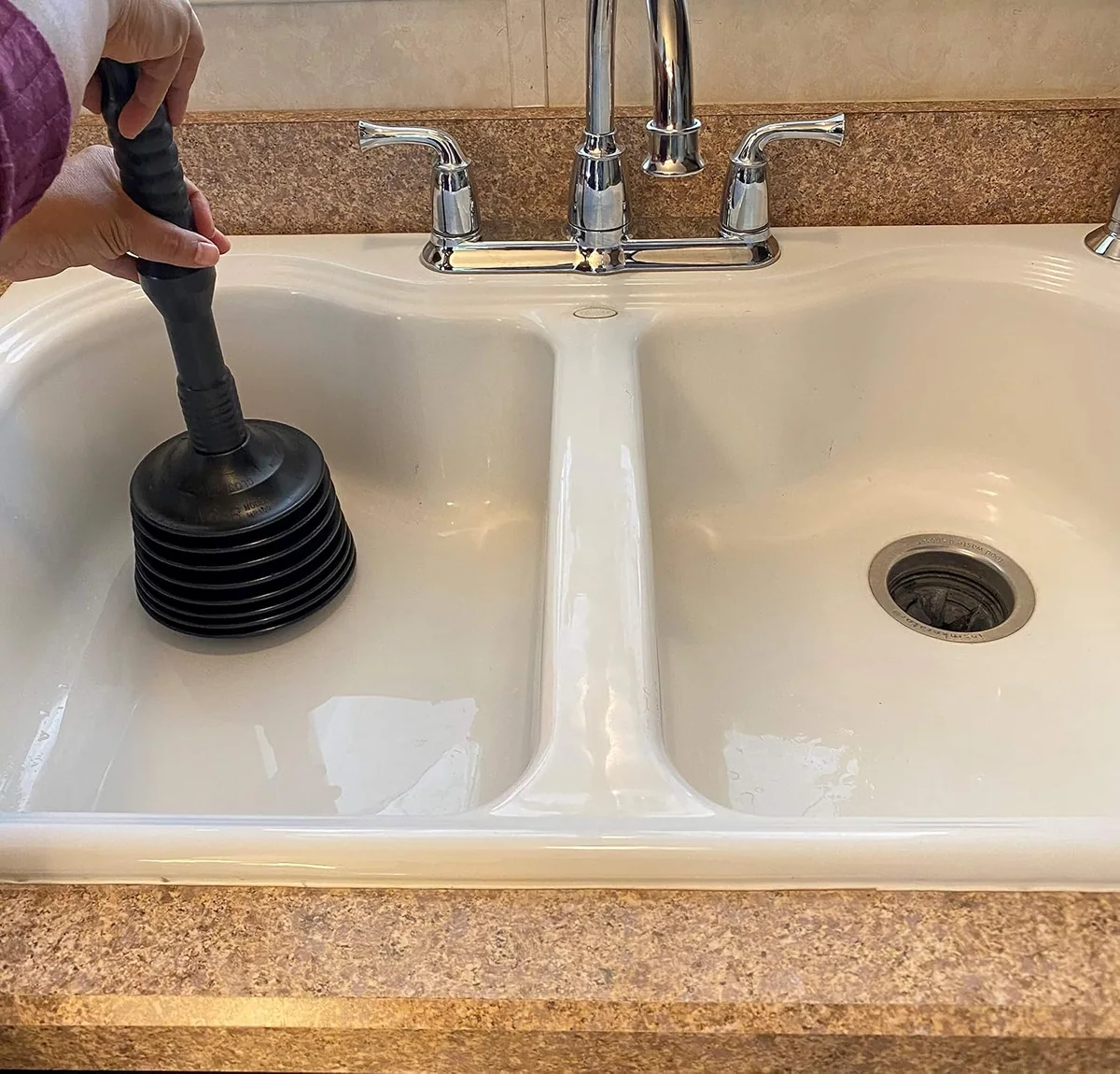 A Master Plunger 100 on a double kitchen sink